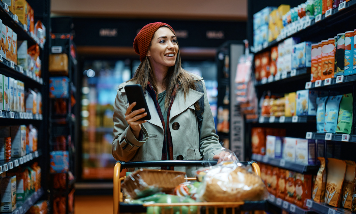 woman grocery shopping with phonw